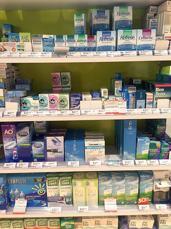 A confusing retail display of common household eye drops in product packaging such as Systane, Biotrue and Blink brands.
